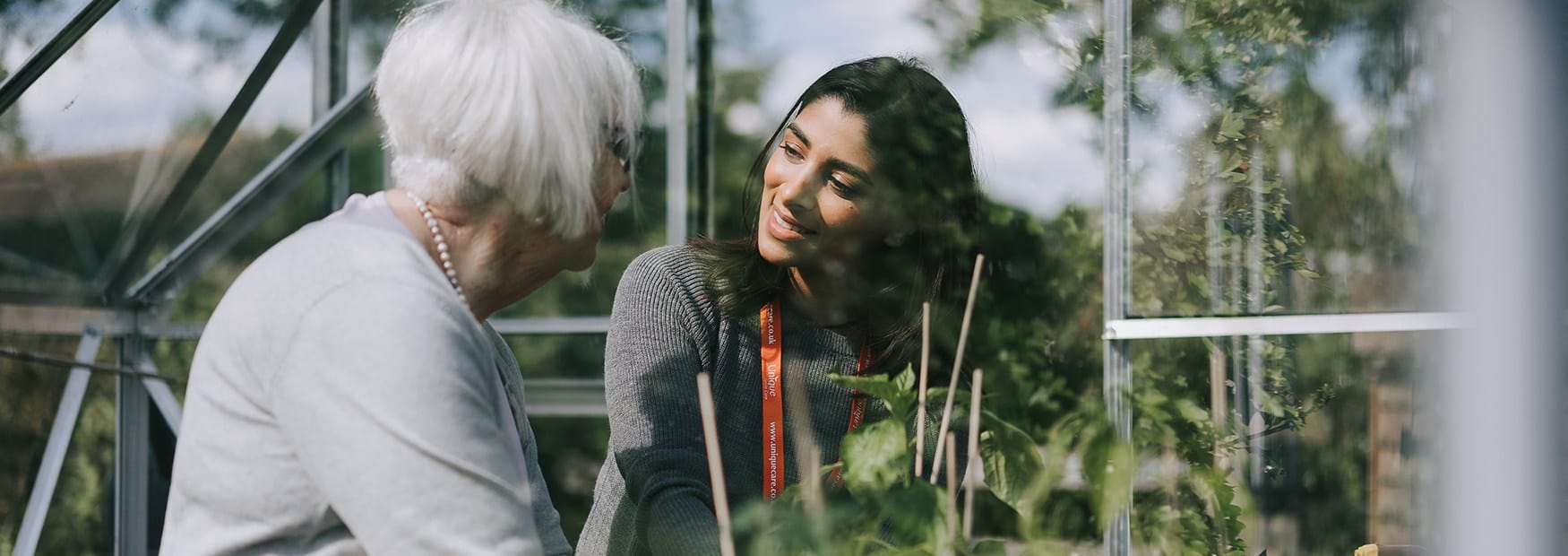 A Unique Senior Care Caregiver spending time with a client in their garden