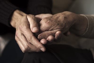 elderly hands touching