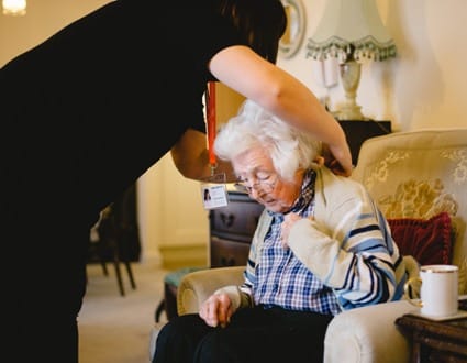 carer helping an elderly lady