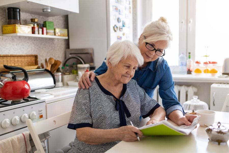 A family member supporting an elderly relative at home
