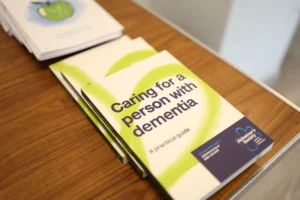 Leaflets titled 'caring for a person with dementia' placed on table