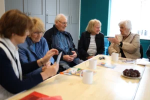 Attendees at the memory cafe sat around a table laughing