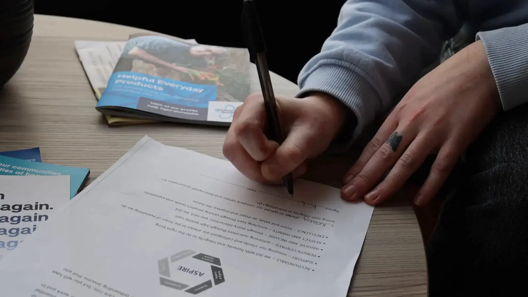 close-up view of Unique Senior Care Caregiver signing the values pledge