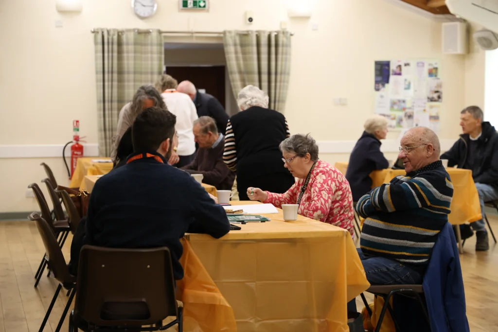 Attendees at the leamington spa and kenilworth memory cafe open day colouring together