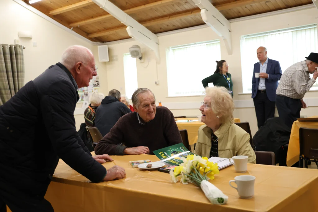 A group of attendees at the leamington spa and kenilworth memory cafe chatting with each other, smiling
