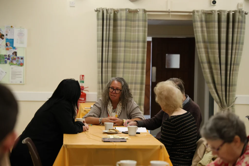 A group of attendees at the leamington spa and kenilworth memory cafe open day chatting together