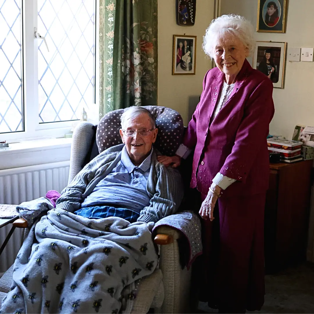 A picture of client Rona and her husband smiling at the camera