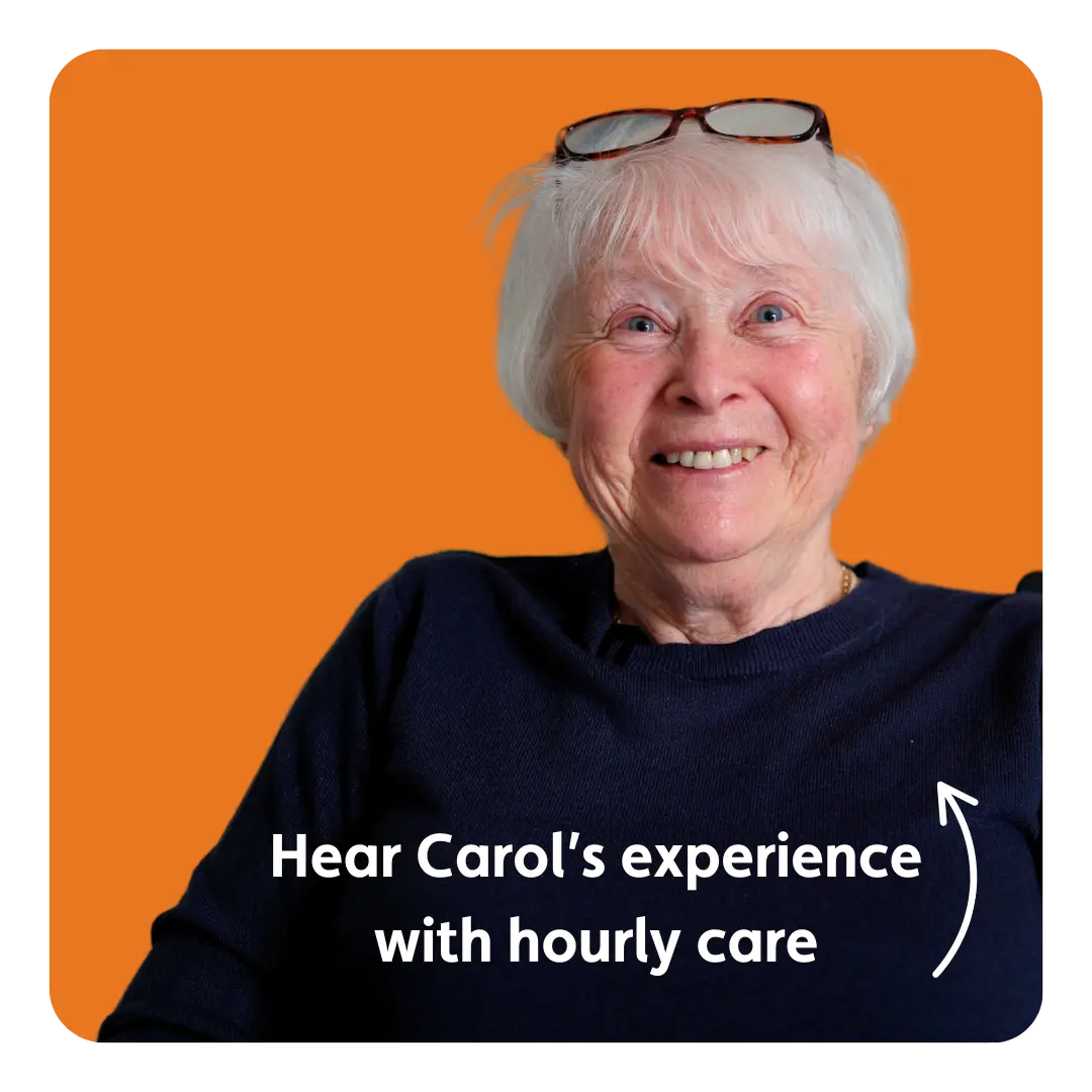 An elderly woman with white hair and glasses resting on her head smiles warmly against an orange background. Text reads, “Hear Carol’s experience with hourly care.”