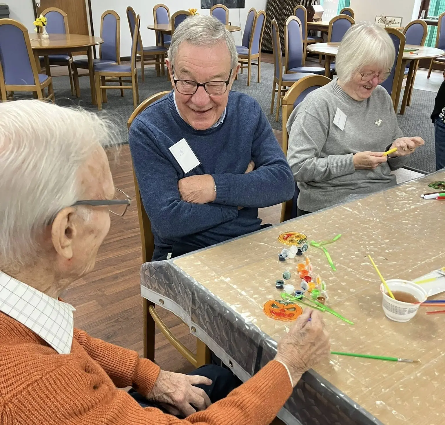 Attendees smiling while enjoying an activity at the Solihull memory cafe