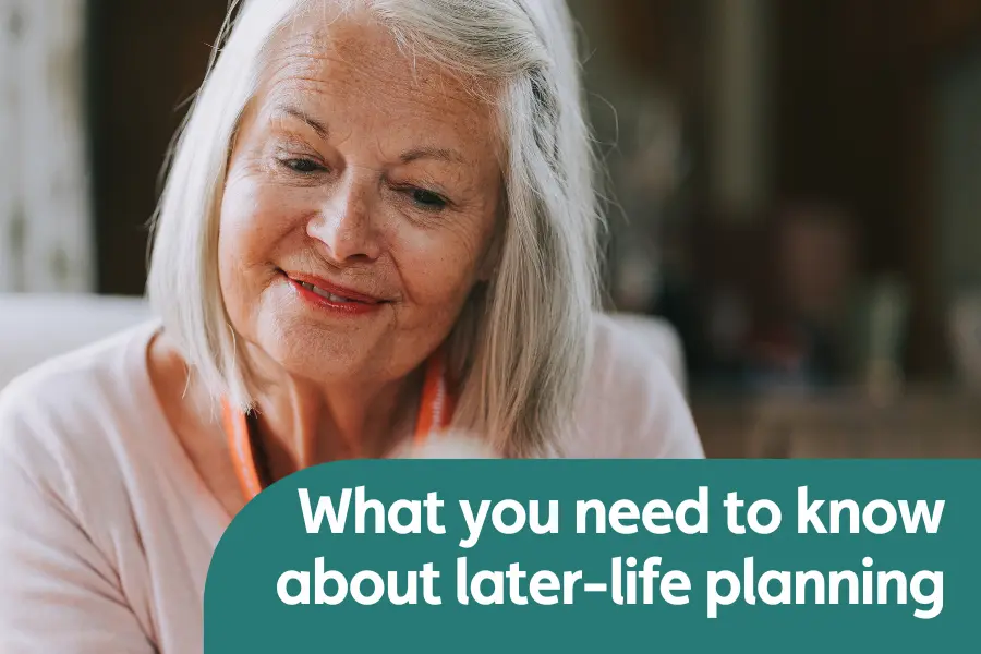 Featured image for blog on later-life planning. Image shows a lady smiling while looking down a a document