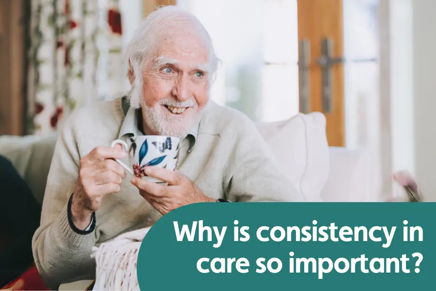Featured image for blog around the importance of consistency in care. Image shows an elderly gentleman holding a cup of tea while smiling at someone