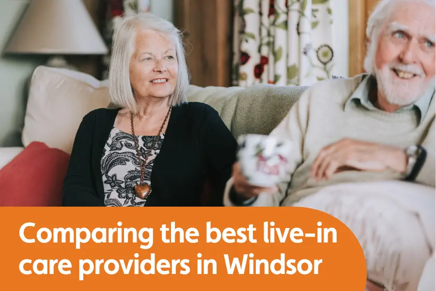 Featured image for blog comparing the top live in care providers in Windsor, image shows woman and elderly gentleman sat on a sofa smiling while talking to someone out of shot