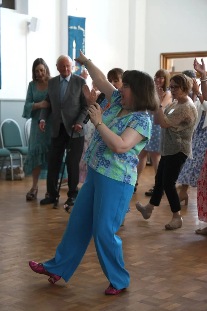 Attendees at the Knowle and Dorridge memory cafe tea dance dancing with instructor, Lynne