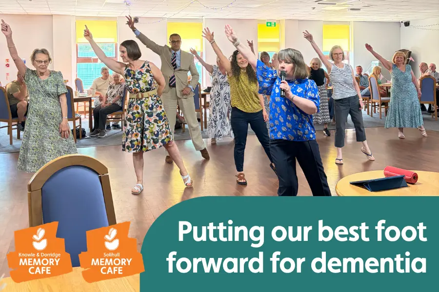 Dance teacher Lynne and attendees at the solihuull memory cafe demonstrating a dance move, overlayed with memory cafe logos and the text 'putting our best foot forward for dementia'