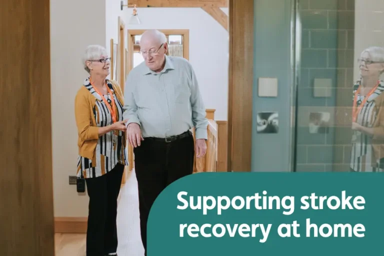 Featured image for blog on stoke recovery at home. Image shows a female caregiver supporting and elderly gentleman with walking