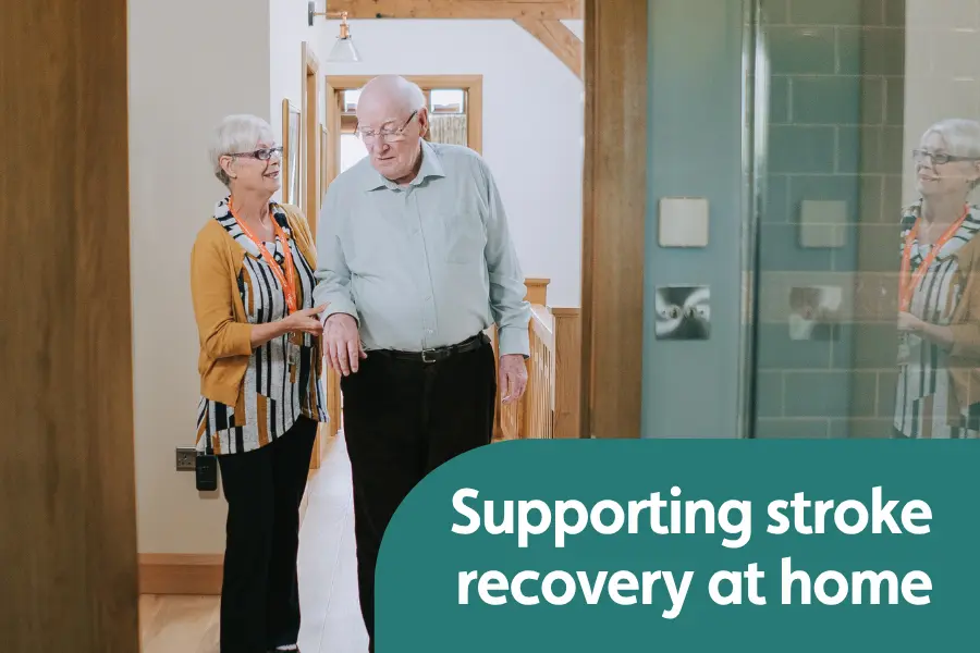 Featured image for blog on stoke recovery at home. Image shows a female caregiver supporting and elderly gentleman with walking